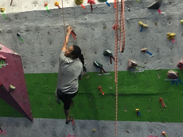 A CAN Lab Member climbing a rock wall
